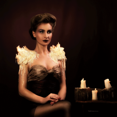 Experience the fusion of past elegance and modern artistry with model Anna Povarova in this captivating image. Hairstyling, makeup, and props by Anett Alexandra Bulano. π―οΈβ¨ #GibsonGirl #ModernElegance #ArtisticVision Modern reinterpretation of the Gibson Girl hairstyle, featuring model Anna Povarova with burning wax candles arranged as shoulder pads.