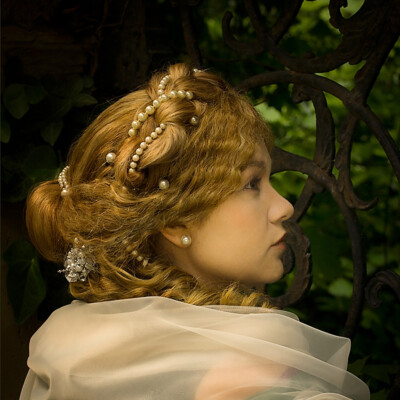 "Transport yourself to the Romantic Era with Lisa V., elegantly adorned in a chignon hairstyle and period attire. π Photographer, makeup artist, and hairstylist: Anett Alexandra Bulano. #RomanticEra #VictorianFashion" "Portrait of Lisa V. dressed in a romantic style with a chignon and a pearled central plait. Styled and photographed by Anett Alexandra Bulano.