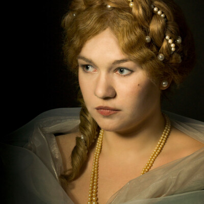 "Transport yourself to the Romantic Era with Lisa V., elegantly adorned in a chignon hairstyle and period attire. π Photographer, makeup artist, and hairstylist: Anett Alexandra Bulano. #RomanticEra #VictorianFashion" "Portrait of Lisa V. in Romantic Era attire, featuring a chignon hairstyle with a central braid adorned with pearls. Styled and photographed by Anett Alexandra Bulano."